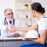 Worker Shakes Hand with Doctor after Discussing Workers' Comp Claim