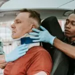 Auto Accident - Paramedic placing a cervical collar on accident victim