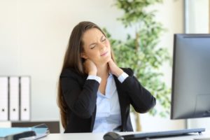 woman suffering neck injury at work