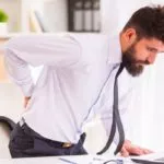 Male employee suffering from osteoarthritis